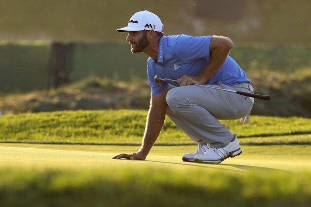 Dustin Johnson lines up his putt on the seventh hole during the rain delayed second round of the U.S. Open golf championship at Oakmont Country Club on Friday, June 17, 2016, in Oakmont, Pa. (AP Photo/Charlie Riedel)