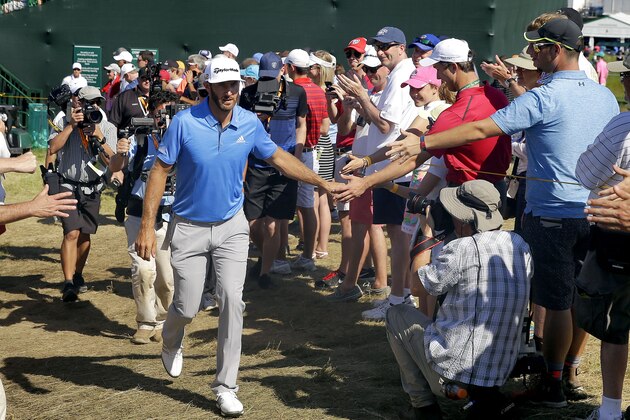 Dustin Johnson greets fans on the way to the 14th tee during the rain delayed second round of the U.S. Open golf championship at Oakmont Country Club on Friday, June 17, 2016, in Oakmont, Pa. (AP Photo/John Minchillo)