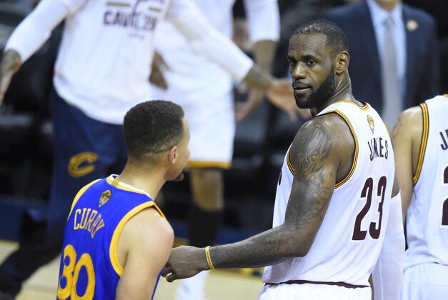 Jun 16, 2016; Cleveland, OH, USA; Cleveland Cavaliers forward LeBron James (23) stares at Golden State Warriors guard Stephen Curry (30) in the fourth quarter in game six of the NBA Finals at Quicken Loans Arena. Cleveland won 115-101. Mandatory Credit: David Richard-USA TODAY Sports