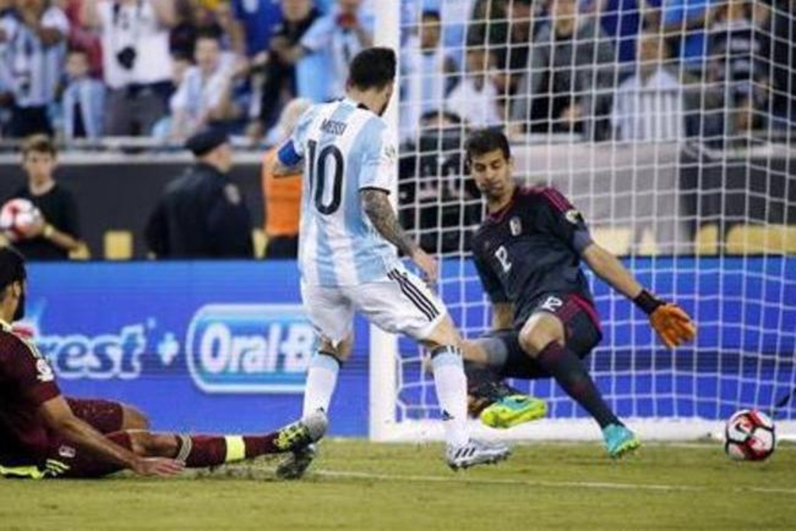 Argentina's Lionel Messi (10) scores a goal against Venezuela's Oswaldo Vizcarrondo (4) and Dani Hernandez (12) during the second half of a Copa America Centenario quarterfinal soccer match Saturday, June 18, 2016, in Foxborough, Mass. (AP Photo/Michael Dwyer) Argentina's Lionel Messi (10) scores a goal against Venezuela's Oswaldo Vizcarrondo (4) and Dani Hernandez (12) during the second half of a Copa America Centenario quarterfinal soccer match Saturday, June 18, 2016, in Foxborough, Mass. (AP Photo/Michael Dwyer)