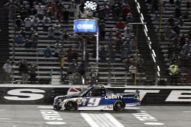 William Byron crosses the finish line to win the NASCAR Trucks Series auto race at Texas Motor Speedway, Friday, June 10, 2016, in Fort Worth, Texas. (AP Photo/Larry Papke)