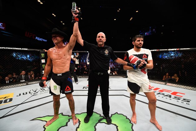 OTTAWA, ON - JUNE 18:   (L-R) Donald Cerrone of the United States celebrates his victory over Patrick Cote of Canada in their welterweight bout during the UFC Fight Night event inside the TD Place Arena on June 18, 2016 in Ottawa, Ontario, Canada. (Photo by Jeff Bottari/Zuffa LLC/Zuffa LLC via Getty Images)