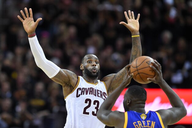 Jun 16, 2016; Cleveland, OH, USA; Cleveland Cavaliers forward LeBron James (23) defends against Golden State Warriors forward Draymond Green (23) during the fourth quarter in game six of the NBA Finals at Quicken Loans Arena. Mandatory Credit: Bob Donnan-USA TODAY Sports