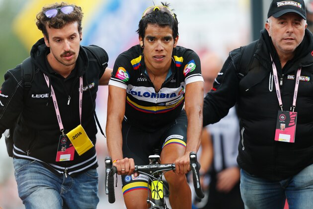AGLIE, ITALY - MAY 24: An exhausted Jarlinson Pantano of Colombia and team Colombia is helped by his team soigneurs after finishing in third place during the fourteenth stage of the 2014 Giro d'Italia, a 164km high mountain stage between Aglie and Oropa on May 24, 2014 in Aglie, Italy.  (Photo by Harry Engels - Velo/Getty Images)