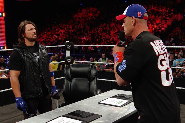John Cena and AJ Styles sign the contract for their first match. John Cena and AJ Styles sign the contract for their first match.