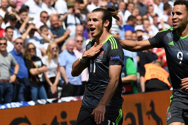 Wales' Gareth Bale, left, celebrates after scoring the opening goal during the Euro 2016 Group B soccer match between England and Wales at the Bollaert stadium in Lens, France, Thursday, June 16, 2016. At right is teammate Hal Robson Kanu. (AP Photo/Geert Vanden Wijngaert)