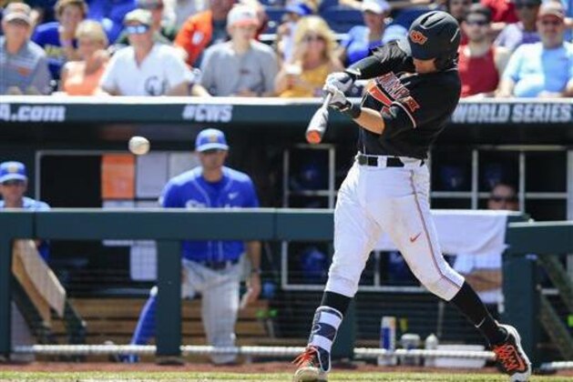 Oklahoma State's Garrett Benge hits an RBI-single that scored Corey Hassel in the fourth inning of an NCAA men's College World Series baseball game against UC Santa Barbara in Omaha, Neb., Saturday, June 18, 2016. (AP Photo/Nati Harnik)