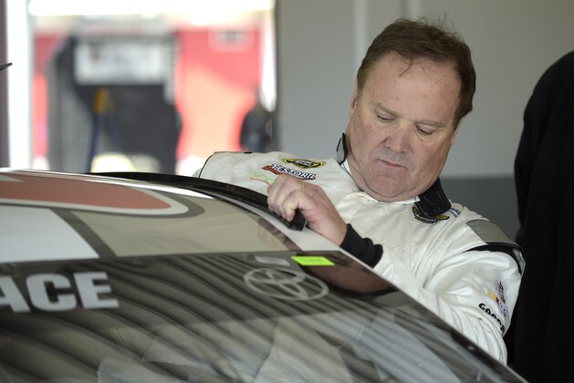 Driver Mike Wallace climbs into his car in the garage during a practice session for the Daytona 500 NASCAR Sprint Cup Series auto race at Daytona International Speedway, Saturday, Feb. 14, 2015, in Daytona Beach, Fla.(AP Photo/Phelan M. Ebenhack)