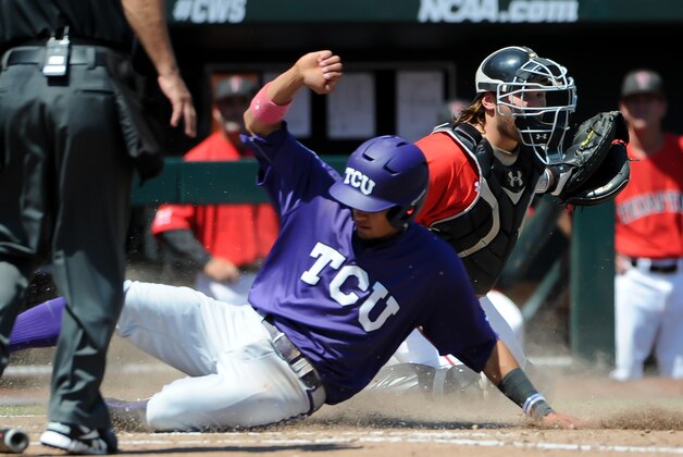 Jun 19, 2016; Omaha, NE, USA; TCU Horned Frogs infielder Elliott Barzilli (3) scores on a fly ball against the Texas Tech Red Raiders in the fourth inning in the 2016 College World Series at TD Ameritrade Park. Mandatory Credit: Steven Branscombe-USA TODAY Sports