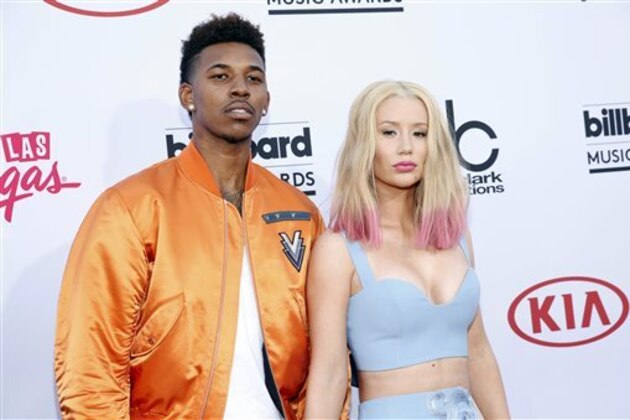 FILE - In this May 17, 2015 file photo, Nick Young, left, and Iggy Azalea arrive at the Billboard Music Awards at the MGM Grand Garden Arena in Las Vegas.  Young proposed to the rapper late Monday, June 1, as they celebrated Young’s 30th birthday. A short video of Azalea saying yes as Young proposed on bended knee was posted on the blog site Karen Civil. The site confirmed its authenticity via email. Azalea will be 25 on Sunday. (Photo by Eric Jamison/Invision/AP, File)