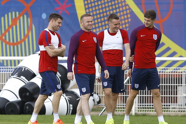 England’s James Milner, left, England’s Wayne Rooney, second left, England’s Jamie Vardy, second right, and John Stones, right, smile during a training session in Chantilly, France, Sunday, June 19, 2016. England will face Slovakia in a Euro 2016 Group B soccer match in Saint-Etienne on Monday, June 20. (AP Photo/Kirsty Wigglesworth)