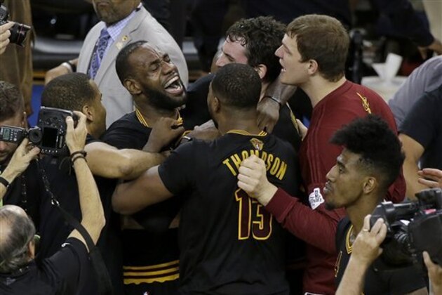 Cleveland Cavaliers forward LeBron James, top left, celebrates with teammates after Game 7 of basketball's NBA Finals against the Golden State Warriors in Oakland, Calif., Sunday, June 19, 2016. The Cavaliers won 93-89. (AP Photo/Eric Risberg)