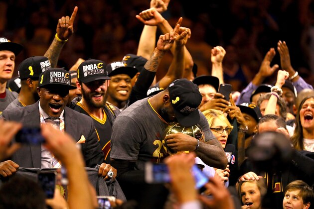 OAKLAND, CA - JUNE 19:  LeBron James #23 of the Cleveland Cavaliers holds the Larry O'Brien Championship Trophy after defeating the Golden State Warriors 93-89 in Game 7 of the 2016 NBA Finals at ORACLE Arena on June 19, 2016 in Oakland, California. NOTE TO USER: User expressly acknowledges and agrees that, by downloading and or using this photograph, User is consenting to the terms and conditions of the Getty Images License Agreement.  (Photo by Ezra Shaw/Getty Images)