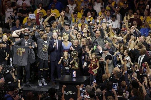 Cleveland Cavaliers players and staff celebrate after Game 7 of basketball's NBA Finals between the Golden State Warriors and the Cavaliers in Oakland, Calif., Sunday, June 19, 2016. The Cavaliers won 93-89. (AP Photo/Eric Risberg)