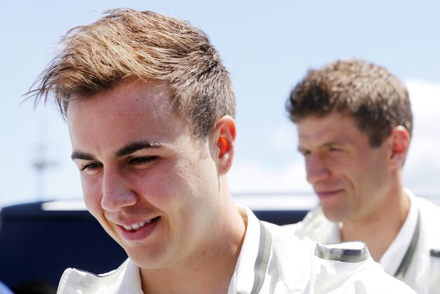 Mario Goetze, left, and Thomas Mueller are on their way to a press conference after a training session of the German national soccer team at their base camp of the German national soccer team in Evian-Les-Bains, France, Sunday, June 19, 2016. Germany will face Northern Ireland in a Euro 2016 Group C soccer match in Paris on Tuesday, June 21, 2016. (AP Photo/Michael Probst)