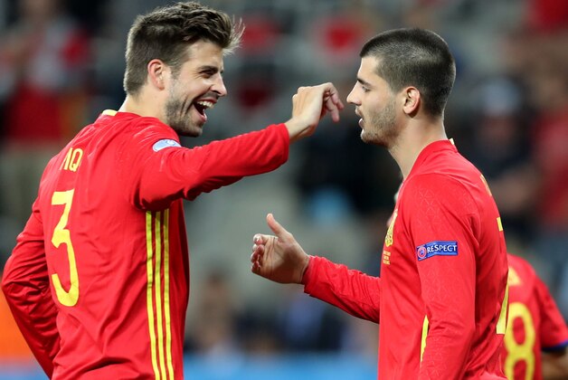 Spain's Alvaro Morata, right, is congratulated by his teammate Gerard Pique after scoring his side's third goal during the Euro 2016 Group D soccer match between Spain and Turkey at the Allianz Riviera stadium in Nice, France, Friday, June 17, 2016. (AP Photo/Claude Paris)