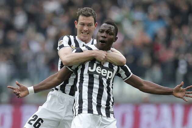 Juventus' Ivorian midfielder Kwadwo Asamoah (R) celebrates with his teammate Stephan Lichtsteiner after scoring during the Italian Serie A football match Juventus vs Chievo Verona at Juventus Stadium in Turin on February 16, 2014.  AFP PHOTO / MARCO BERTORELLO        (Photo credit should read MARCO BERTORELLO/AFP/Getty Images)