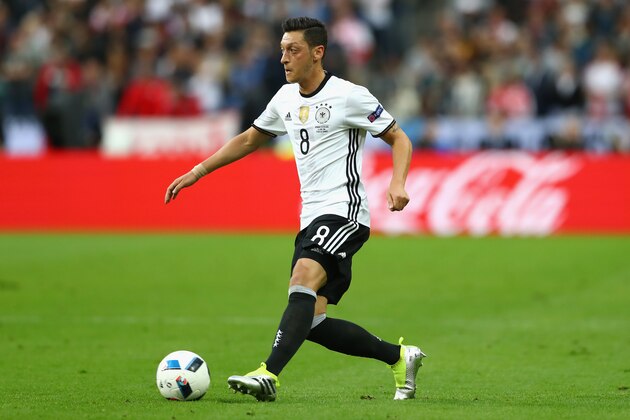 PARIS, FRANCE - JUNE 16:  Mesut Oezil of Germany runs with the ball during the UEFA EURO 2016 Group C match between Germany and Poland at Stade de France on June 16, 2016 in Paris, France.  (Photo by Alexander Hassenstein/Getty Images)