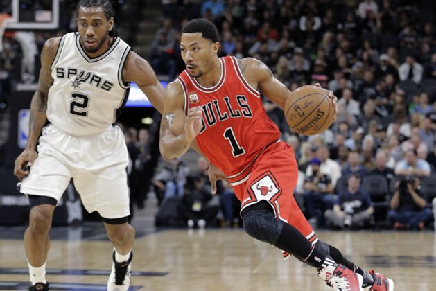 Chicago Bulls guard Derrick Rose (1) drives around San Antonio Spurs forward Kawhi Leonard (2) during the first half of an NBA basketball game, Thursday, March 10, 2016, in San Antonio. (AP Photo/Eric Gay)