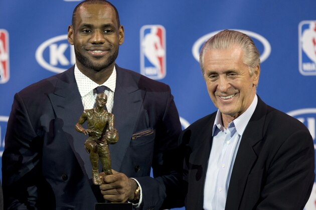 In this May 5, 2013 photo, Miami Heat NBA basketball player LeBron James, left, holds his NBA Most Valuable Player award as he poses with team president Pat Riley, in Miami. Before James makes his next decision, Riley will get a chance to convince him to stay in Miami. Two people familiar with the situation told The Associated Press late Sunday night, July 6, 2014, that James will meet with the Heat president this week before making a decision about where to play next season. (AP Photo/J Pat Carter)
