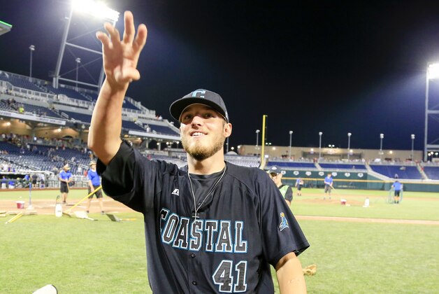 Coastal Carolina pitcher Andrew Beckwith who pitched a complete game against Florida in an NCAA men's College World Series baseball game in Omaha, Neb., Sunday, June 19, 2016, acknowledges fans . Coastal Carolina won 2-1. (AP Photo/Nati Harnik)