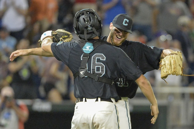 Coastal Carolina pitcher Andrew Beckwith, rear, hugs Coastal Carolina catcher Matt Beaird (16) after the final out of an NCAA men's College World Series baseball game against Florida in Omaha, Neb., Sunday, June 19, 2016. Coastal Carolina won 2-1. (AP Photo/Mike Theiler)