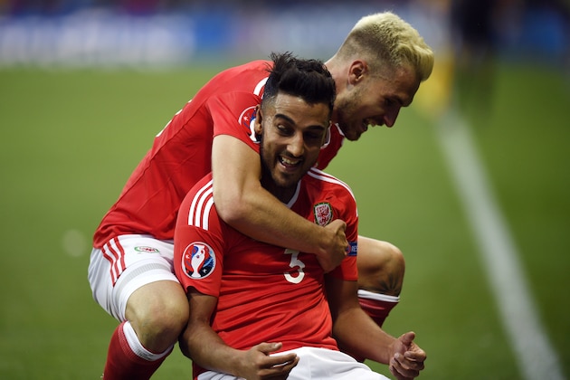 Wales' midfielder Aaron Ramsey (top) who scored the first goal celebrates with Wales' defender Neil Taylor who scored the team's second goal during the Euro 2016 group B football match between Russia and Wales at the Stadium Municipal in Toulouse on June 20, 2016. / AFP / MARTIN BUREAU        (Photo credit should read MARTIN BUREAU/AFP/Getty Images)