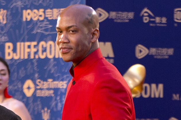 Beijing Ducks basketball player Stephon Marbury gestures as he arrives for the grand opening of the 5th annual Beijing International Film Festival in Beijing, Thursday, April 16, 2015. (AP Photo/Mark Schiefelbein)