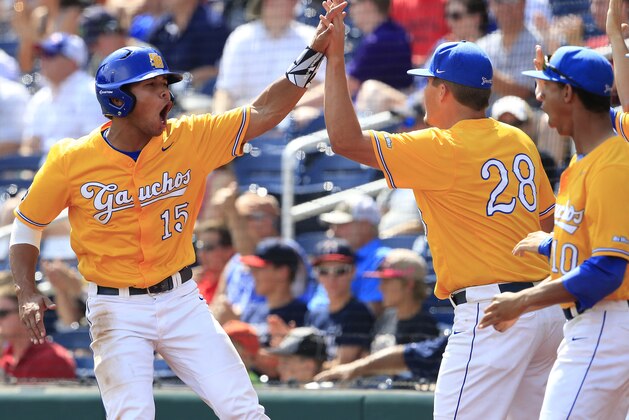UC Santa Barbara's Devon Gradford (15) celebrates with Joe Record (28) after scoring during during the sixth inning of an NCAA College World Series baseball game against Miami, Monday, June 20, 2016, in Omaha, Neb. (AP Photo/Nati Harnik)