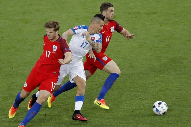 Slovakia's Marek Hamsik fights for the ball against England's Eric Dier and Jordan Henderson during the Euro 2016 Group B soccer match between Slovakia and England at the Geoffroy Guichard stadium in Saint-Etienne, France, Monday, June 20, 2016. (AP Photo/Michael Sohn)