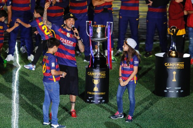 Barcelona's Brazilian defender Dani Alves speaks next to his children during celebrations at the Camp Nou stadium in Barcelona on May 23, 2016 following their Spanish 'Copa del Rey' (King's Cup) final football match 2-0 victory over Sevilla FC yesterday also marking the club's 28th Copa del Rey win and the 24th Spanish Liga title. / AFP / PAU BARRENA        (Photo credit should read PAU BARRENA/AFP/Getty Images)