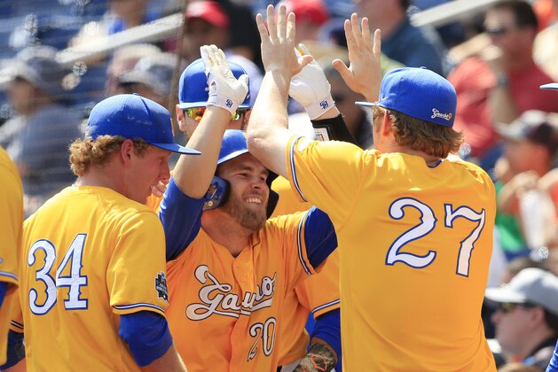 UC Santa Barbara's Dempsey Grover (20) celebrates with Blake Ogburn (27) after scoring during the sixth inning of an NCAA College World Series baseball game against Miami, Monday, June 20, 2016, in Omaha, Neb. (AP Photo/Nati Harnik)