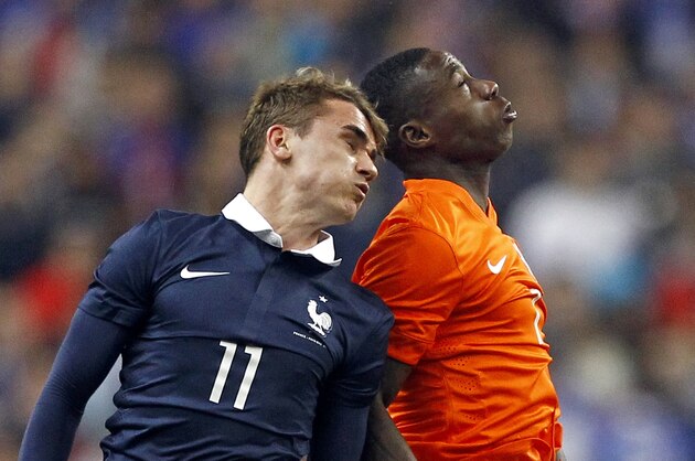 Netherlands' Quincy Promes, right, and France's Antoine Griezmann jump to head the ball, during the friendly soccer match between France and Netherlands at the Stade de France in Saint Denis, north of Paris, Wednesday March 5, 2014. France won 2-0.(AP Photo/Remy de la Mauviniere)