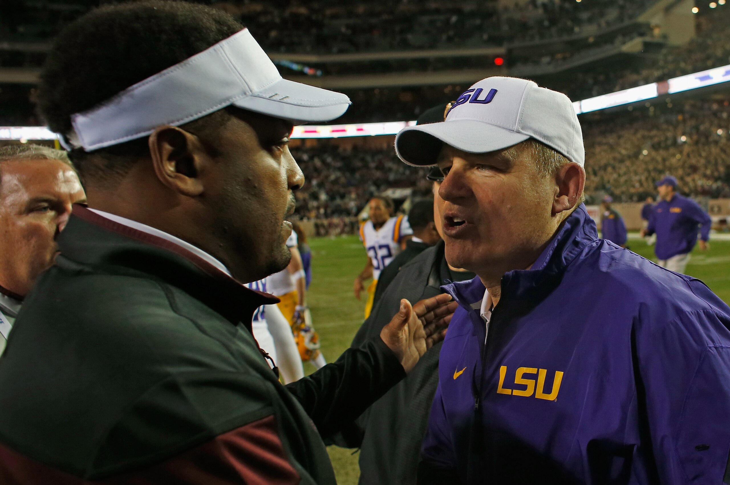COLLEGE STATION, TX - NOVEMBER 27:  Texas A&M Aggies head coach Kevin Sumlin (L) greets head coach Les Miles of the LSU Tigers on the field after the Tigers won 23-17 at Kyle Field on November 27, 2014 in College Station, Texas.  (Photo by Scott Halleran/Getty Images)