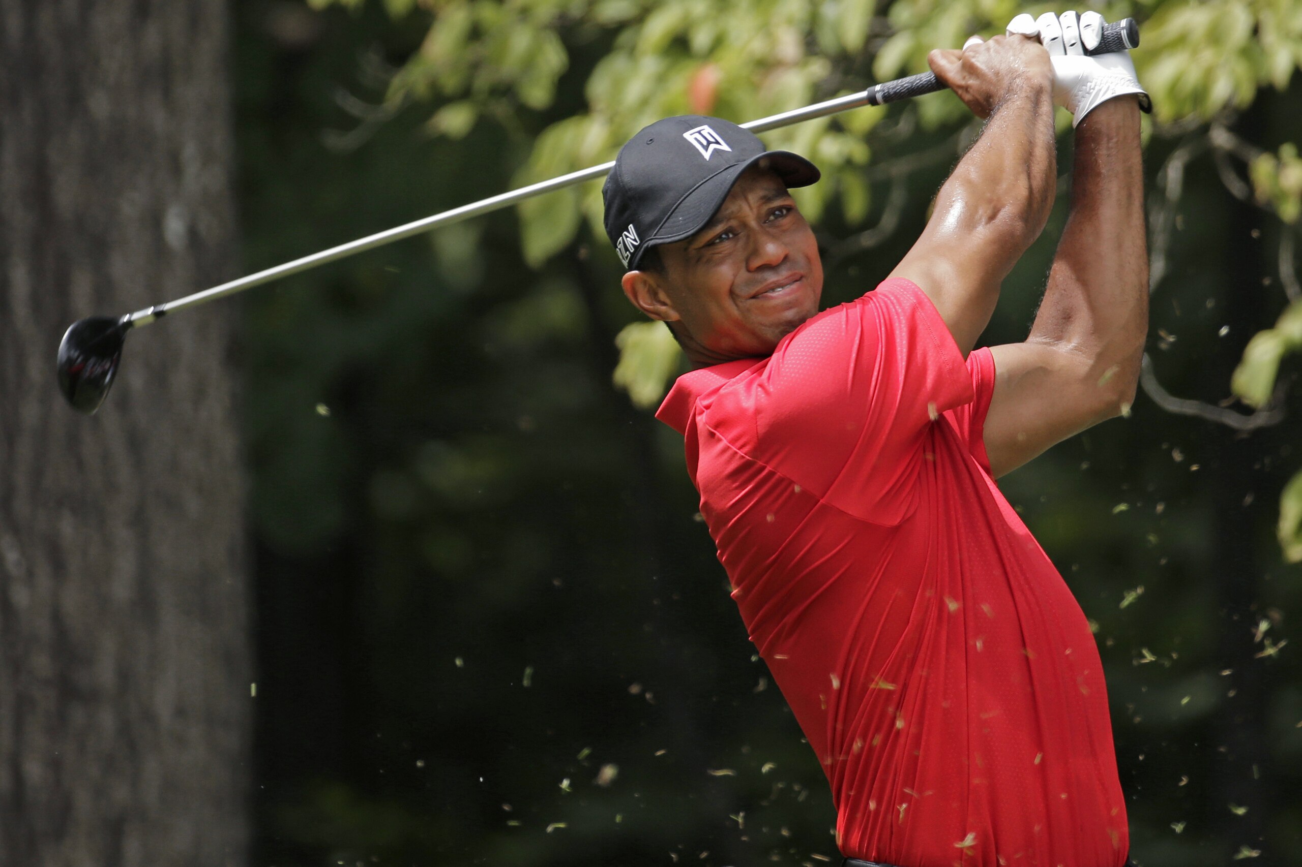 FILE - In this Aug. 23, 2015, file photo, Tiger Woods watches his tee shot on the second hole during the final round of the Wyndham Championship golf tournament at Sedgefield Country Club in Greensboro, N.C. Tiger Woods registered for the U.S. Open, which was more procedure than pronouncement. Three weeks later, he played five holes during the official opening of the golf course he designed outside Houston. The next step is returning to competition, which remains unknown. (AP Photo/Chuck Burton, File)