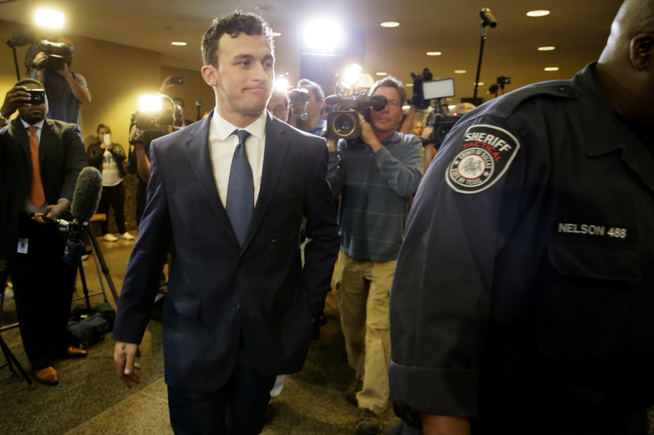Former Cleveland Browns quarterback Johnny Manziel arrives at court for his initial appearance, Thursday, May 5, 2016, in Dallas. The Heisman Trophy winner and former Texas A&M star was indicted by a grand jury last month after his ex-girlfriend alleged he hit her and threatened to kill her during a night out in January.  (AP Photo/LM Otero)