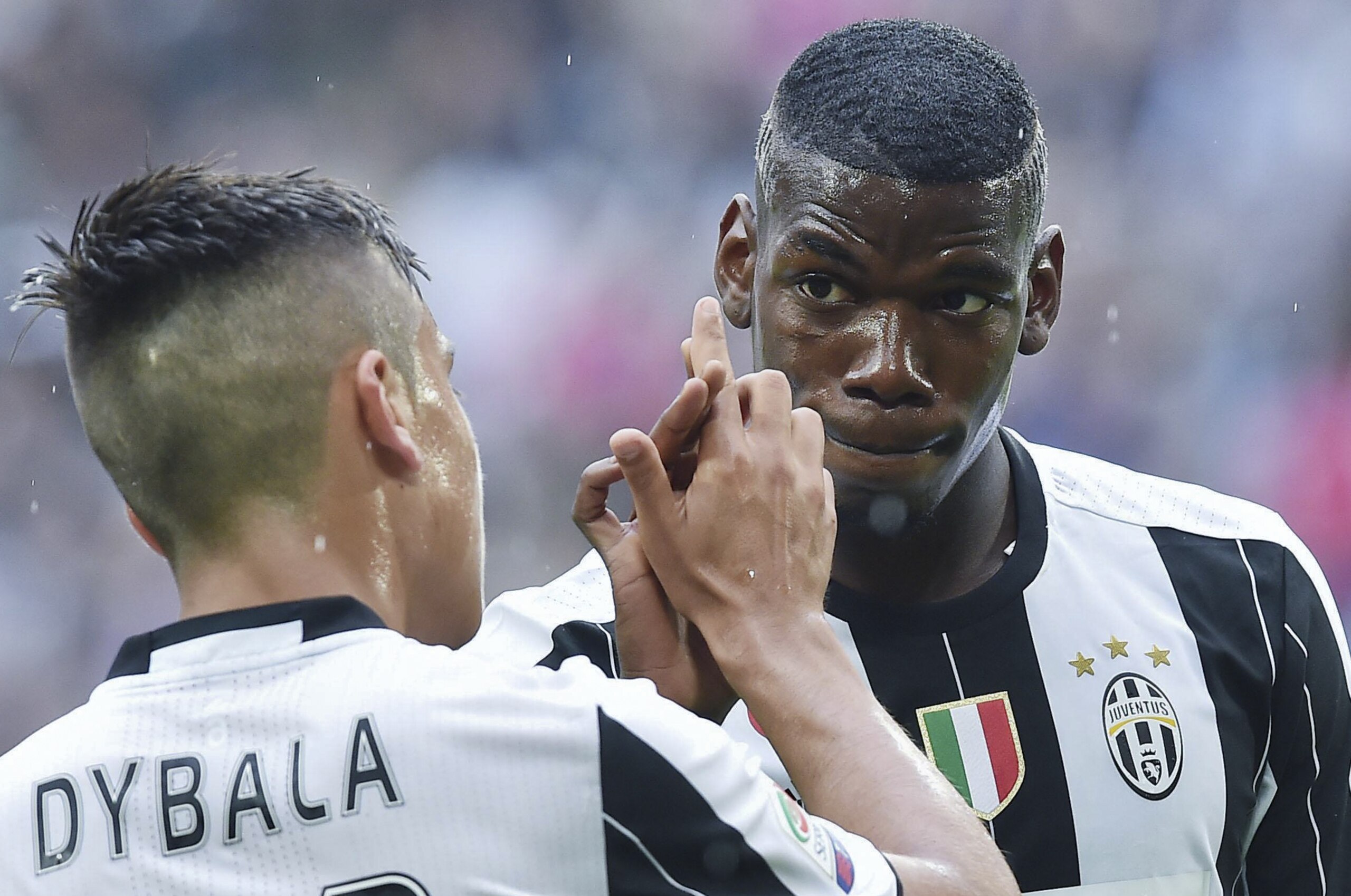 Juventus' Paulo Dybala, left, celebrates with teammate Paul Pogba after scoring during a Serie A soccer match between Juventus and Sampdoria, at the Turin Juventus stadium Saturday, May 14, 2016. (Alessandro Di Marco/ANSA via AP)