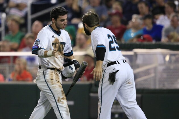 Coastal Carolina's Michael Paez (1) celebrates with Anthony Marks (29) after scoring against TCU during the sixth inning of an NCAA College World Series baseball game, Tuesday, June 21, 2016, in Omaha, Neb. (AP Photo/Nati Harnik)