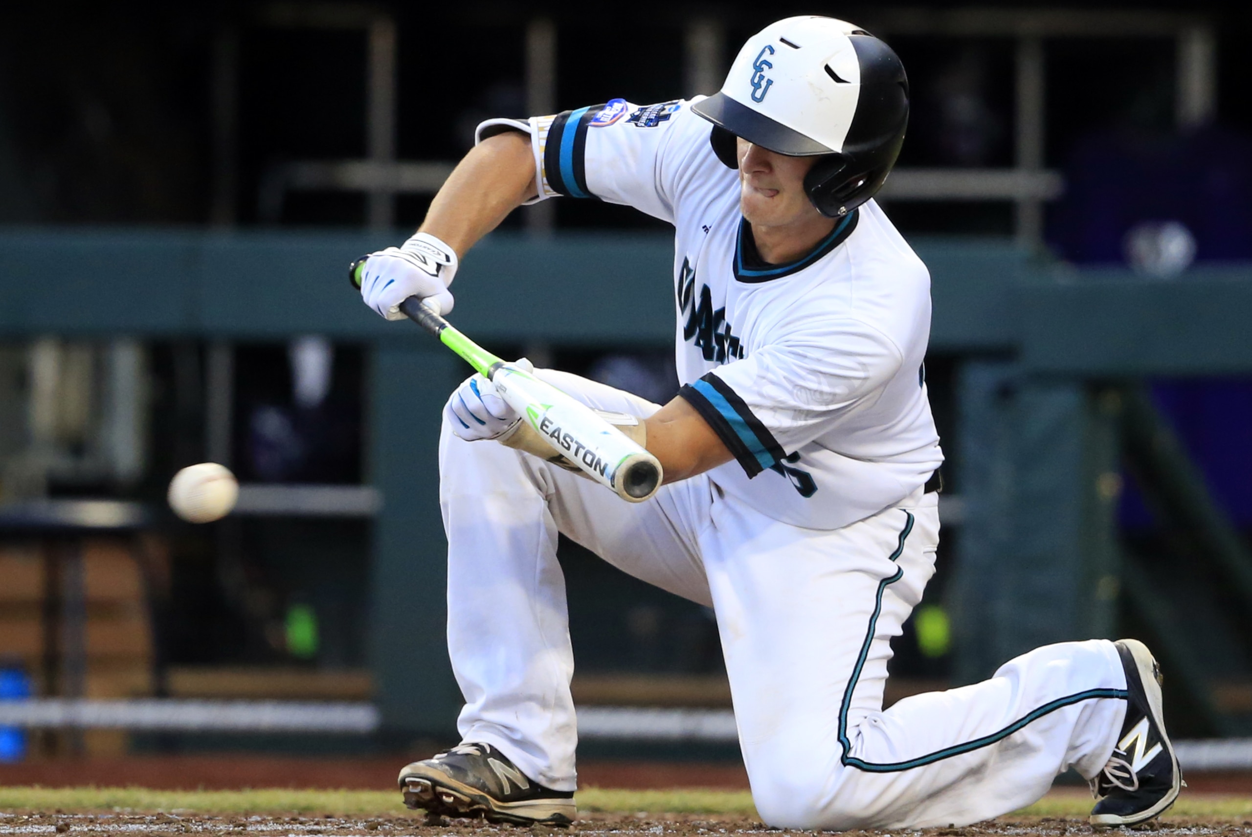 Coastal Carolina's Matt Beaird puts down a sacrifice bunt during the third inning of an NCAA College World Series baseball game against TCU, Tuesday, June 21, 2016, in Omaha, Neb. (AP Photo/Nati Harnik)