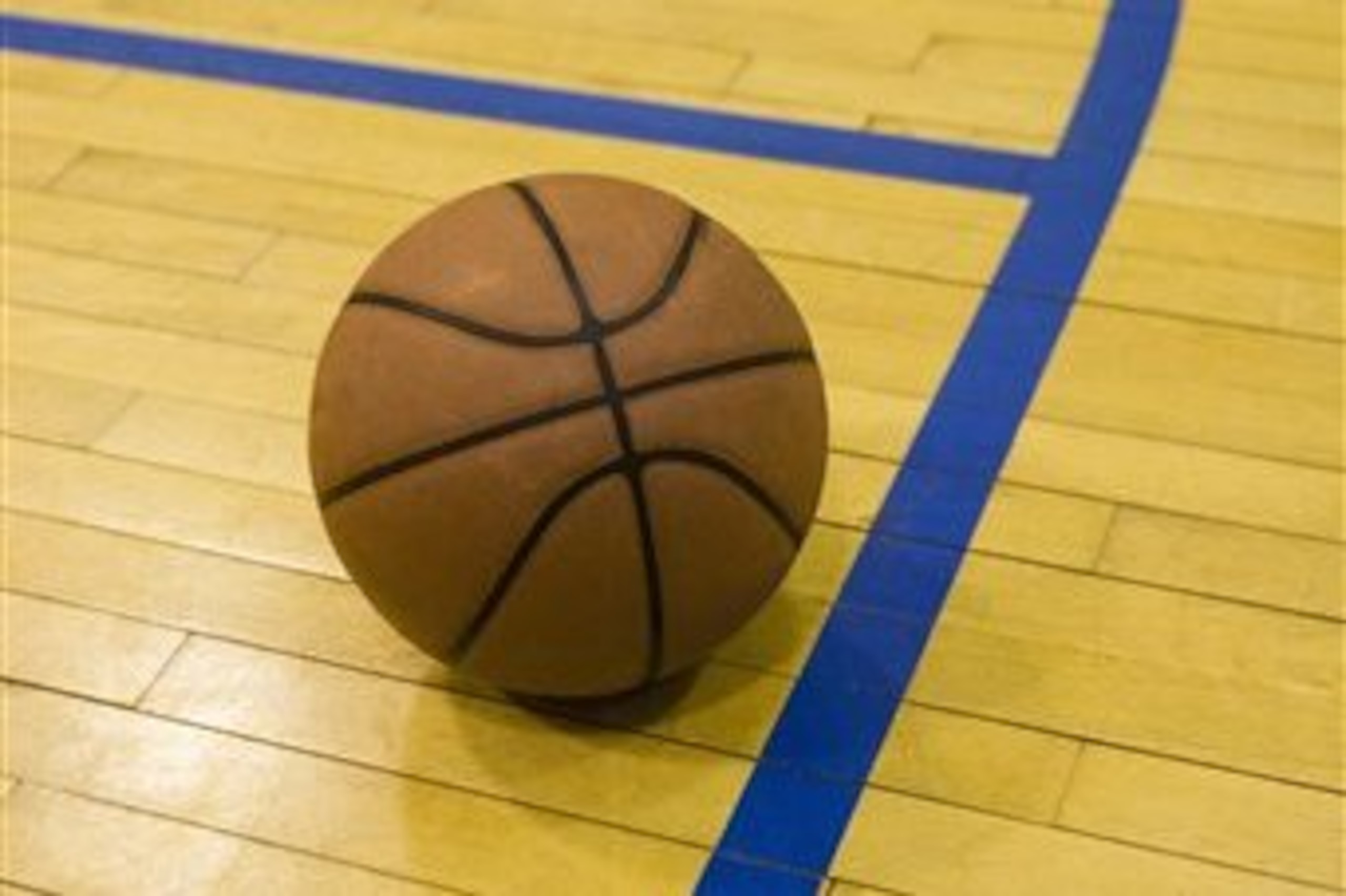 Close up of basketball on basketball court (Photo by: Tetra Images/AP Images)