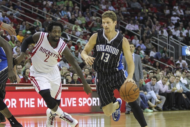 Mar 17, 2015; Houston, TX, USA; Orlando Magic guard Luke Ridnour (13) drives the ball during the fourth quarter as Houston Rockets guard Patrick Beverley (2) defends at Toyota Center. Mandatory Credit: Troy Taormina-USA TODAY Sports