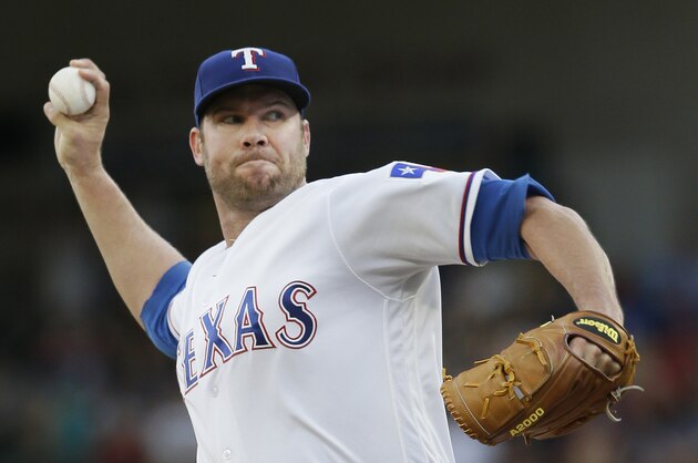 Texas Rangers starting pitcher Colby Lewis throws during the first inning of a baseball game against the Cincinnati Reds in Arlington, Texas, Tuesday, June 21, 2016. (AP Photo/LM Otero)