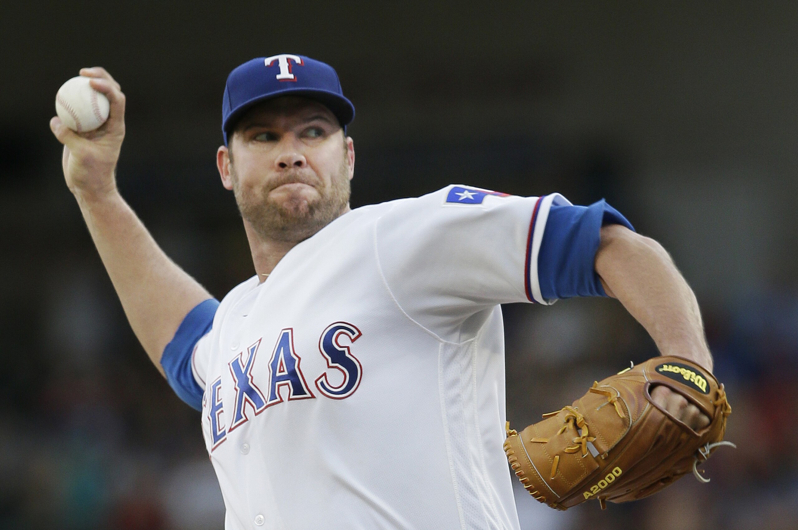 Texas Rangers starting pitcher Colby Lewis throws during the first inning of a baseball game against the Cincinnati Reds in Arlington, Texas, Tuesday, June 21, 2016. (AP Photo/LM Otero)