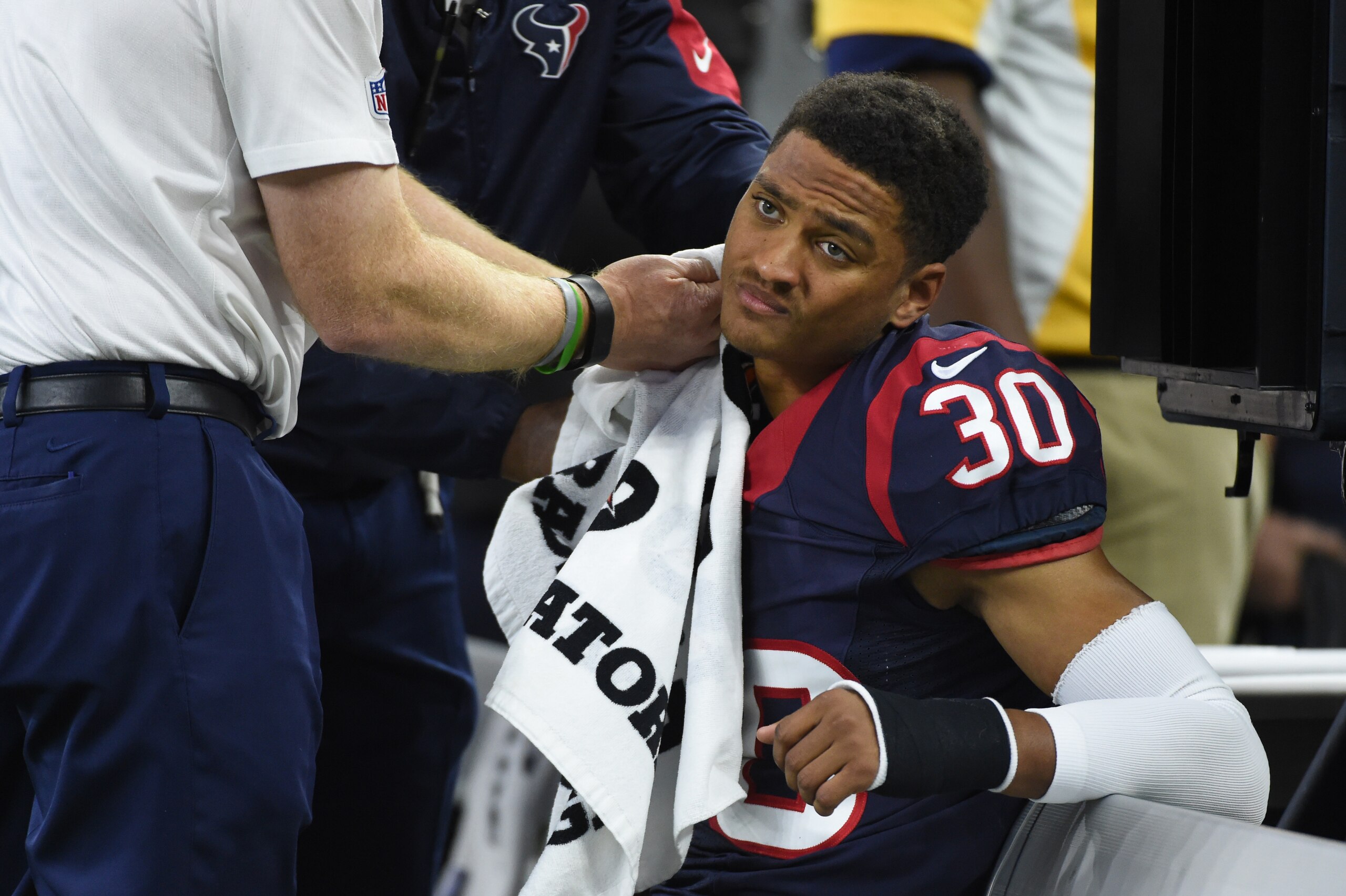 Houston Texans cornerback Kevin Johnson (30) is tended to during the second half of an NFL wild-card playoff football game Saturday, Jan. 9, 2016, in Houston. (AP Photo/Eric Christian Smith)