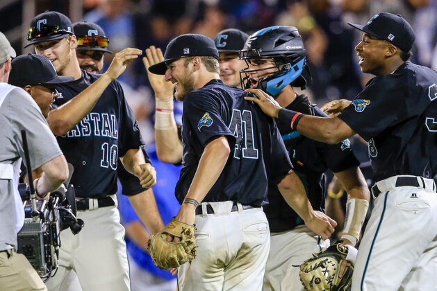Coastal Carolina pitcher Andrew Beckwith (41), who pitched a complete game, is surrounded by celebrating teammates following an NCAA men's College World Series baseball game against Florida in Omaha, Neb., Sunday, June 19, 2016. Coastal Carolina won 2-1. (AP Photo/Nati Harnik)