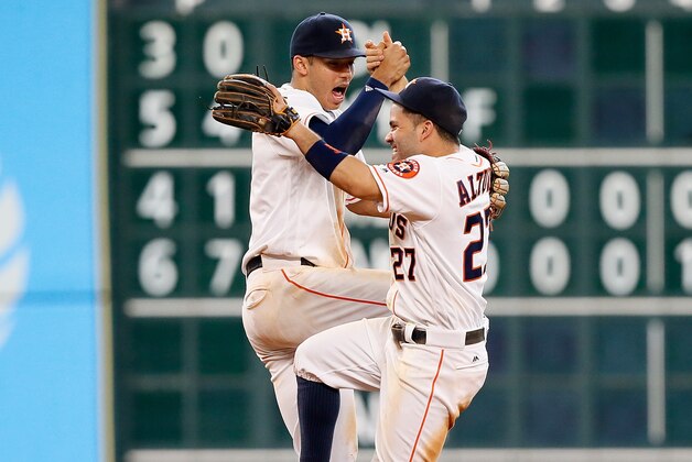 HOUSTON, TX - JUNE 22:  Jose Altuve #27 of the Houston Astros and Carlos Correa #1 celebrate their 3-2 win over the Los Angeles Angels of Anaheim at Minute Maid Park on June 22, 2016 in Houston, Texas.  (Photo by Bob Levey/Getty Images)