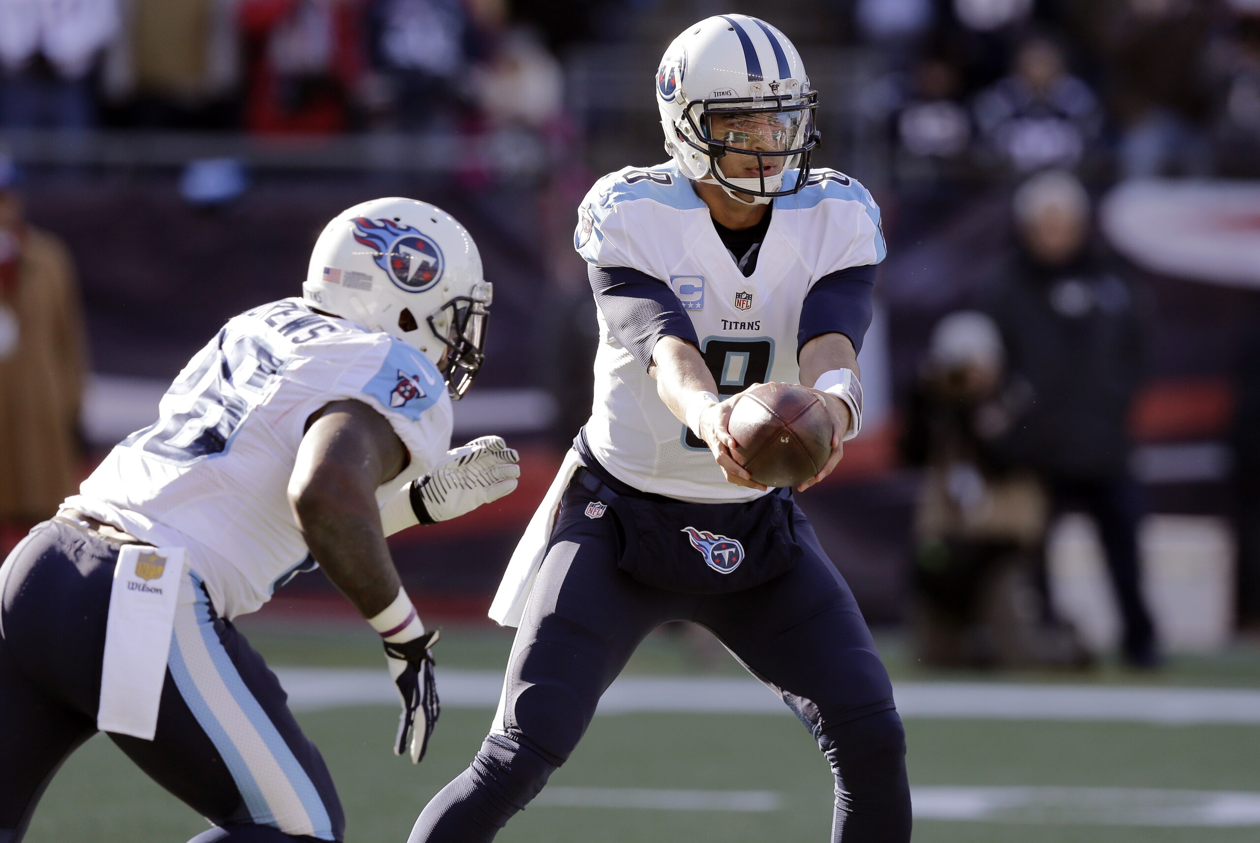Tennessee Titans quarterback Marcus Mariota (8) hands off to running back Antonio Andrews (26) in the first half of an NFL football game against the New England Patriots, Sunday, Dec. 20, 2015, in Foxborough, Mass. (AP Photo/Charles Krupa)