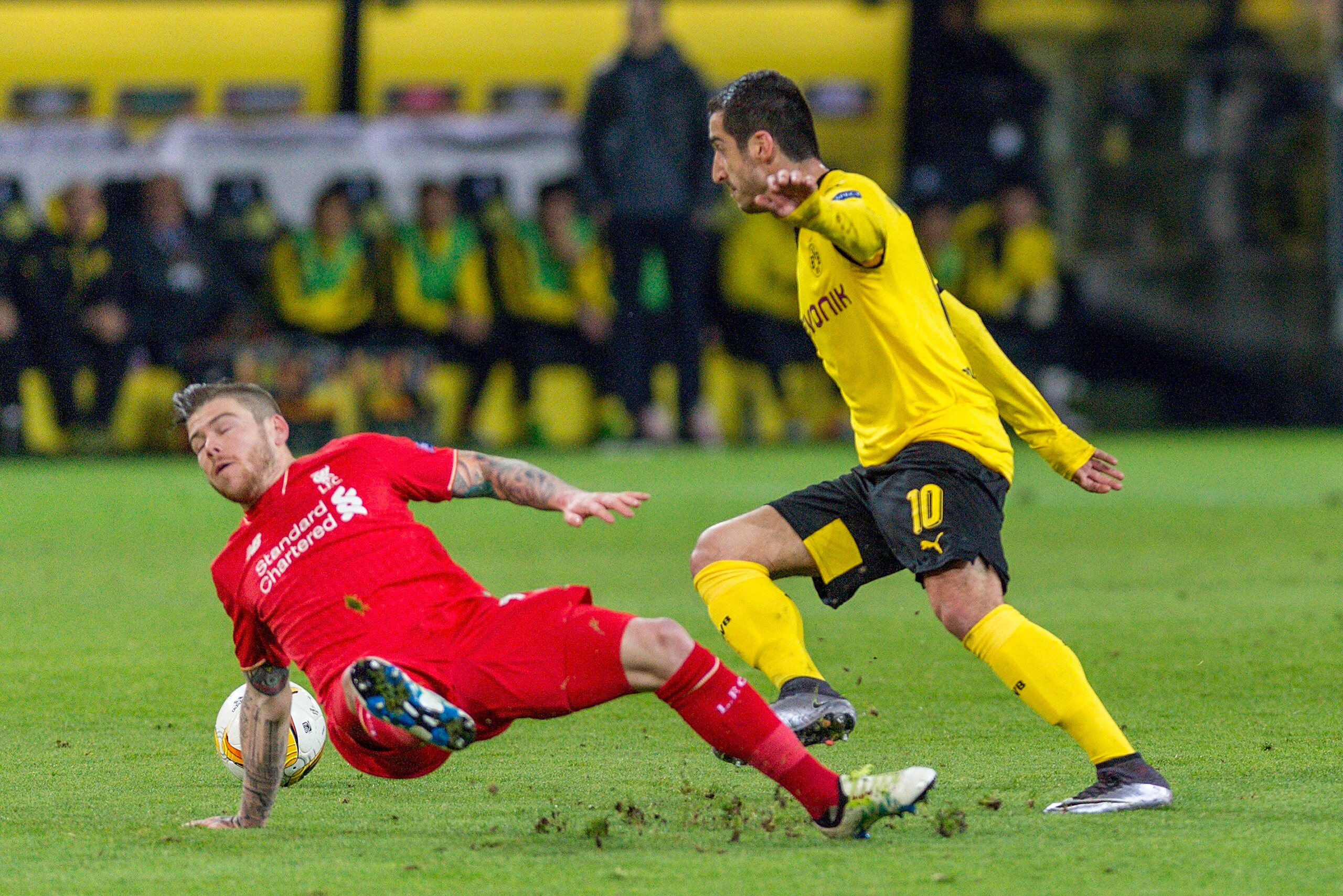 DORTMUND, GERMANY - APRIL 07: Defense Alberto Moreno (18) of FC Liverpool and Midfielder Henrikh Mkhitaryan (10) of Borussia Dortmund fighting for the ball at Signal Iduna Park during the UEFA Europa League quarter final first leg match between Borussia Dortmund and Liverpool on April 07, 2016 in Dortmund, Germany. (Photo by Oliver Kremer at Pixolli Studios/Getty Images) DORTMUND, GERMANY - APRIL 07: Defense Alberto Moreno (18) of FC Liverpool and Midfielder Henrikh Mkhitaryan (10) of Borussia Dortmund fighting for the ball at Signal Iduna Park during the UEFA Europa League quarter final first leg match between Borussia Dortmund and Liverpool on April 07, 2016 in Dortmund, Germany. (Photo by Oliver Kremer at Pixolli Studios/Getty Images)