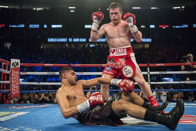 May 7, 2016; Las Vegas, NV, USA; Canelo Alvarez (red shorts) knocks out Amir Khan (maroon shorts) during their middleweight boxing title fight at T-Mobile Arena. Mandatory Credit: Joshua Dahl-USA TODAY Sports