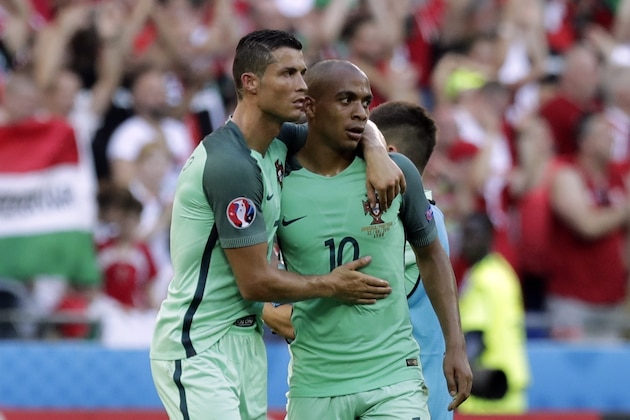 Portugal's Cristiano Ronaldo, left, embraces Portugal's Joao Mario at the end of the Euro 2016 Group F soccer match between Hungary and Portugal at the Grand Stade in Decines-Charpieu, near Lyon, France, Wednesday, June 22, 2016. (AP Photo/Pavel Golovkin)